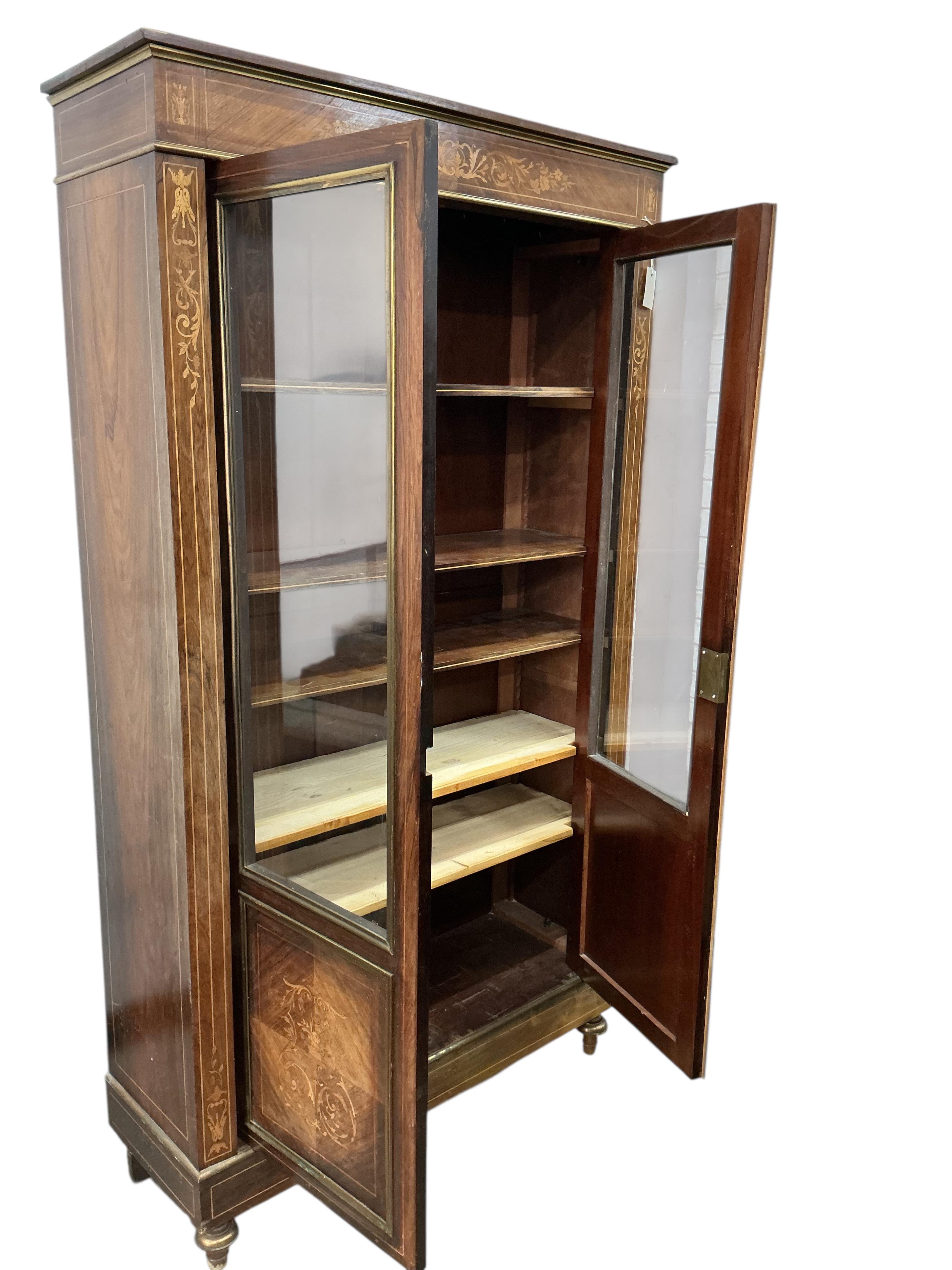 An early 20th century French brass mounted marquetry inlaid rosewood bookcase, width 104cm, depth 35cm, height 187cm